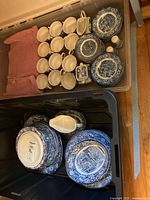 overview of cups, saucers, small accessories in clear tote