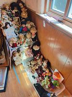Overall view of shelf and bin full of dolls and plush toys