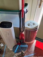 Group shot of all five appliances: Honeywell air purifier, Holmes heater, Dirt Devil stick vacuum, two portable dehumidifiers