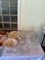 Group shot of ceramic Mikasa pieces and clear glassware on table