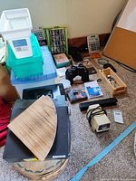 Overall lot with bins, decor, electronics and tools visible