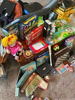 Overall lot showing board games, toys and accessories grouped together