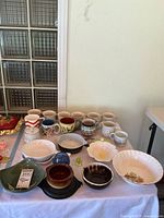 Group shot of all mugs, bowls and dishes on table