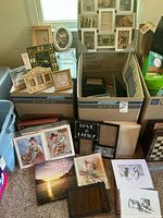 Group of frames, prints, books and decor laid out and boxed