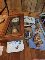 front view of clock and scattered art pieces on floor