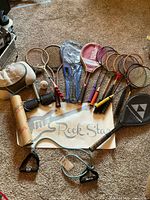 Group shot of all rackets, fitness accessories, glove and banner
