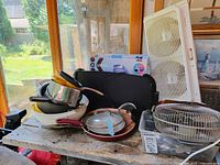 Entire lot showing cookware stack, boxed Keurig, twin window fan, black case