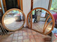Both mirrors leaning against wall showing sizes and frame styles