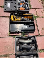 Three open cases showing Ridgid nailer, DeWalt reciprocating saw, Craftsman circular saw