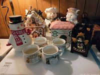 Front view showing all cookie jars, mugs and lantern