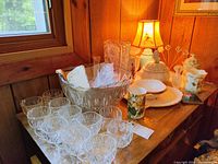 Overall view of punch bowl, cups, porcelain pieces and lamp on table