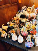 Overall lot showing multiple animal figurines grouped on table