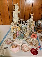 Overall lot showing figurines, vases, dishes and candle holders