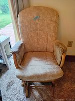 Front view of glider rocking chair showing upholstery and frame