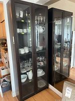 Full view of cabinet with glass doors and shelves