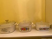 Three casserole dishes with lids side by side