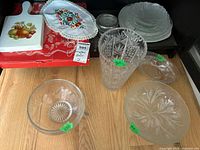 Overall view of shelf contents showing crystal vase, bowls, pressed glass items, ceramic trivet and doily