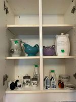 Cabinet view showing all ceramic items on two shelves
