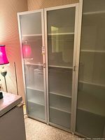 Front view of both tall IKEA frosted glass corner cabinets