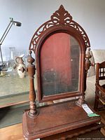Front view of vintage wood vanity mirror on base