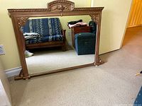 Front view of ornate wood framed mirror
