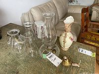 Group shot showing both oil lamps, extra chimneys, vase and exit sign cover