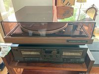 Turntable on top of cassette deck, dust cover closed