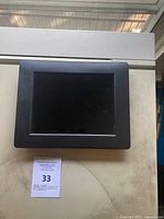 Front view of the AluraTek digital photo frame showing the 7x9 inch display and black bezel.