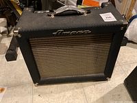 Front view of amplifier showing tolex covering, grille cloth and logo.