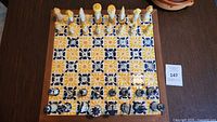 Top view of Talavera tile chessboard with all chess pieces arranged.