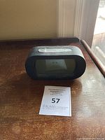 Battery powered digital clock radio front view showing digital display and buttons