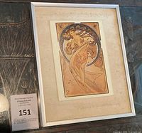 Framed Art Nouveau style print by Alphonse Mucha in silver frame showing the entire piece.
