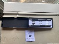 Image showing two black styluses with multiple interchangeable tips in original box.