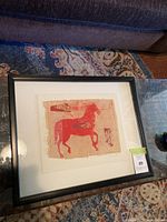 Framed art piece with a red horse image on textured paper with a white mat and black frame, showing overall lot content.