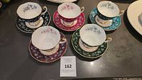 Five Royal Albert Chateau Series teacup and saucer sets arranged on a table showing all sets in full view.