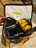 Overhead photo showing a yellow Kodak branded camera bag with a yellow Kodak camera and other camera accessories inside.