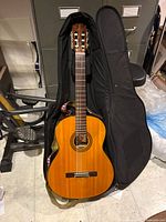 Yamaha G-230 classical guitar laid in open gig bag showing top, rosette, fretboard and headstock