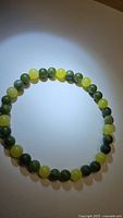 Photo of the natural green jade and lemon jade round bead bracelet showing bead color and size.
