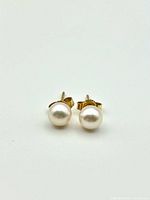 Front view of both pearl stud earrings