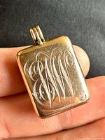 Front view showing rectangular shape and engraved monogram