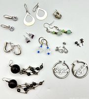 Overview of 11 sterling silver earring pairs laid out