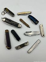 Group layout of all eleven pocket multi-tools showing variety of handle styles and tool configurations