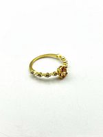 Ring profile showing orange centre stone and clear crystal accents