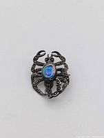 Front view of scorpion brooch showing abalone cabochon and marcasite detail