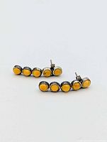 Full view of both earrings showing five amber cabochons in each sterling setting