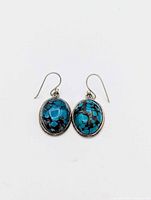 Front view of both oval turquoise sterling silver earrings