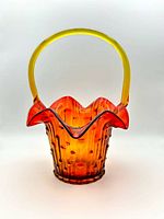 Front view showing color gradient, handle and ruffled rim