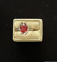 Ring front view in box showing ruby and setting