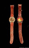 Front view of both Disney The Lion King watches showing faces and braided bands