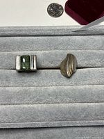 Two modernist rings side by side on display pad